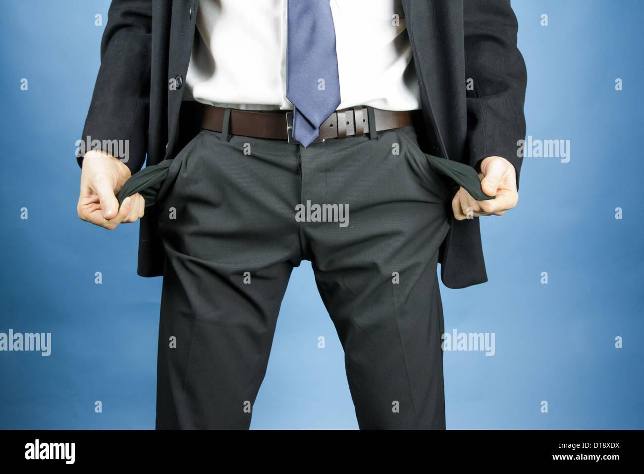 businessman showing empty pockets in pants Stock Photo Alamy