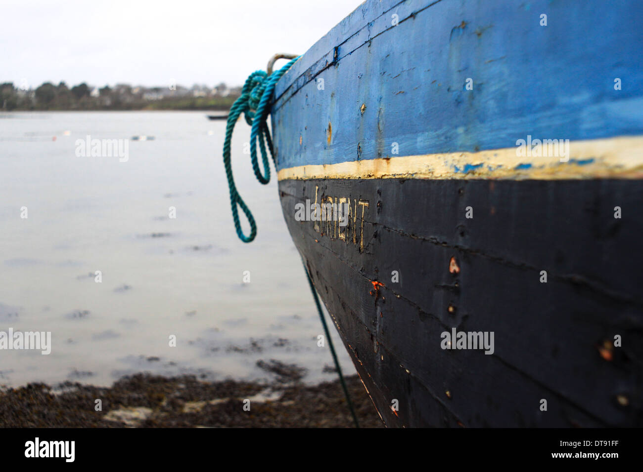 Wooden boat on the rocky beach Stock Photo