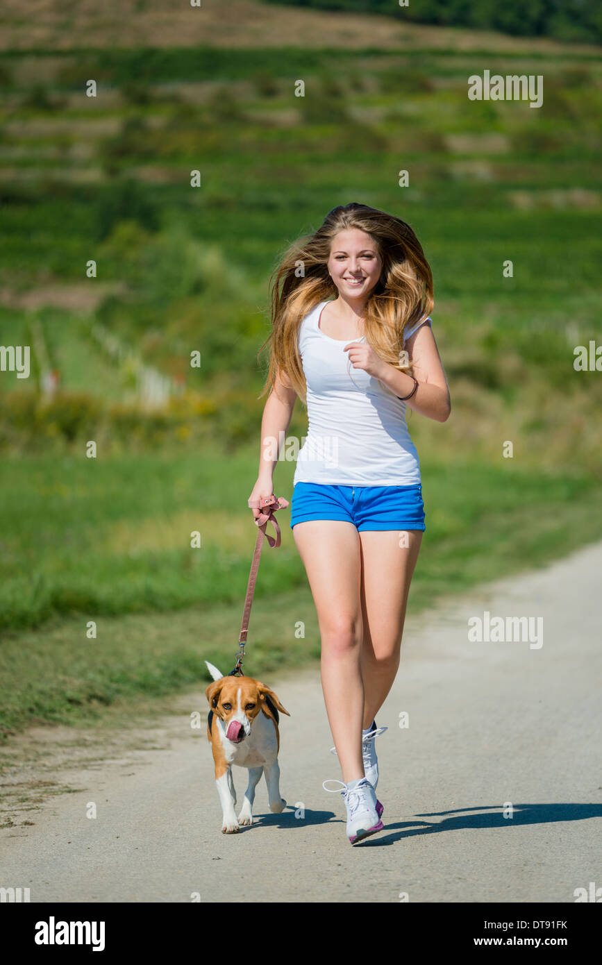 Beautiful teenage girl jogging with her pet (beagle dog) in nature Stock  Photo - Alamy