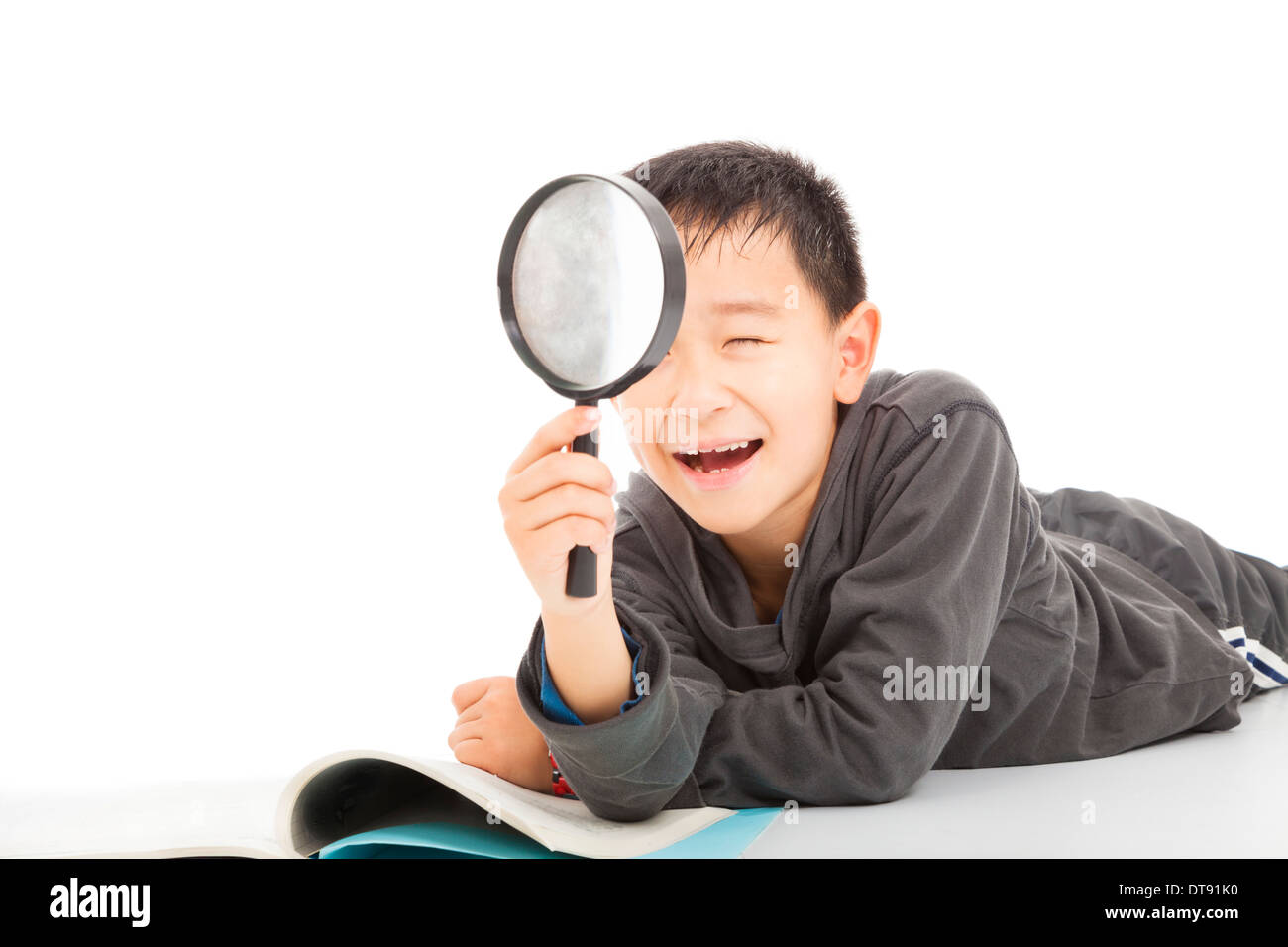 happy kid with magnifying glass and book over white background Stock Photo