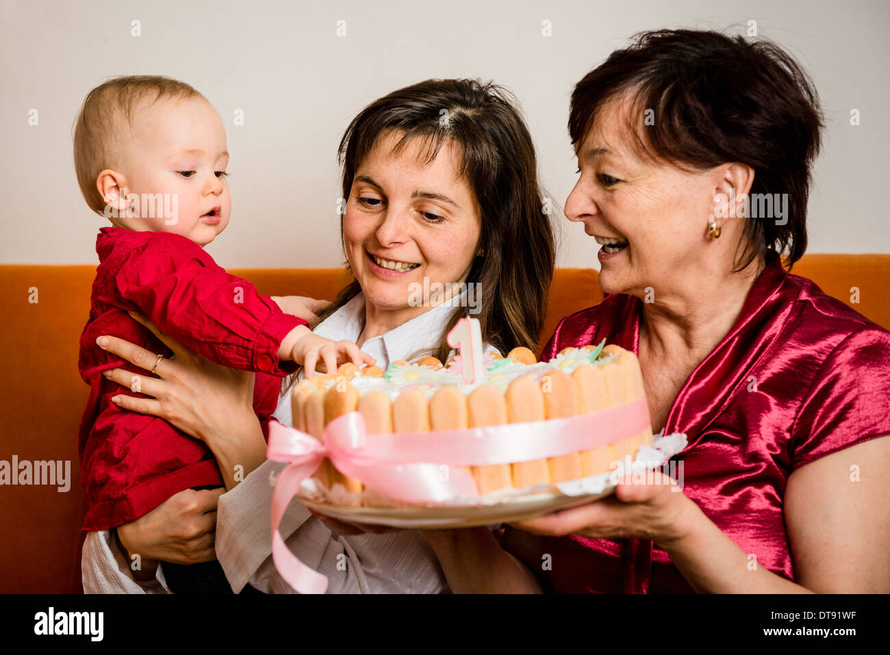 Mother and grandmother with small baby celebrating first birthday Stock Photo