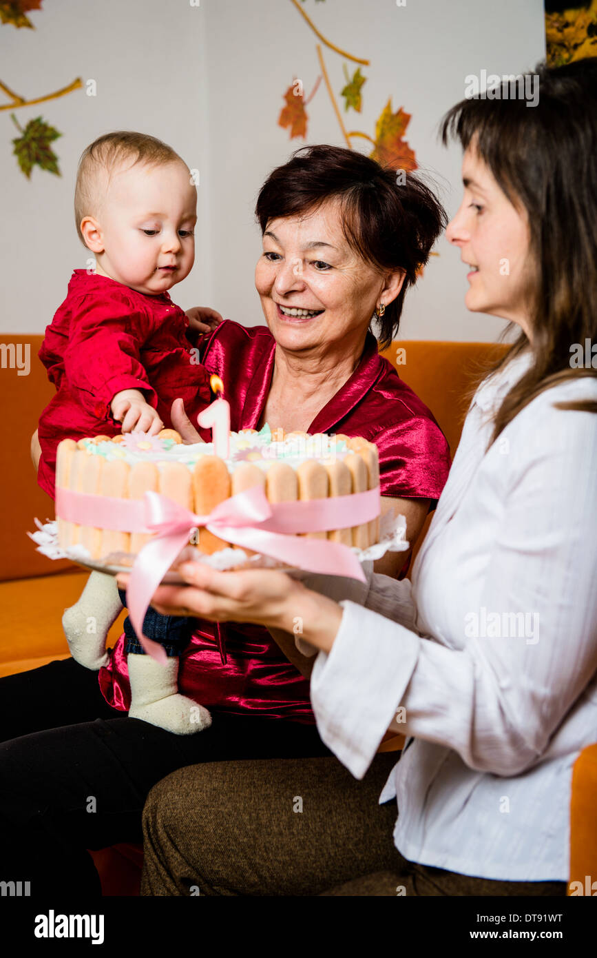 Mother and grandmother with small baby celebrating first birthday Stock Photo
