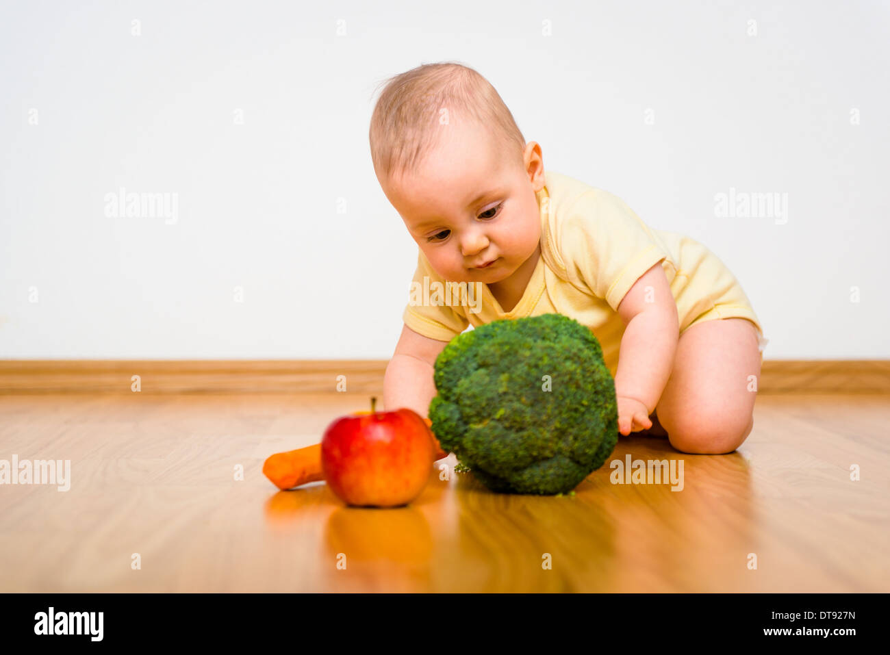 Baby exploring fruit and vegetables - healthy lifestyle Stock Photo