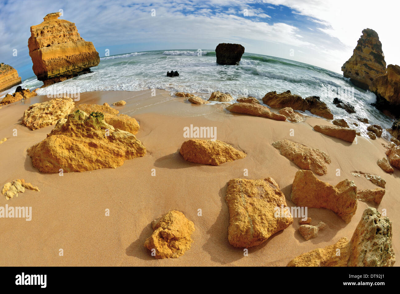 Portugal, Algarve: Rocks and waves at beach Praia da Marinha seen with fisheye perspective Stock Photo