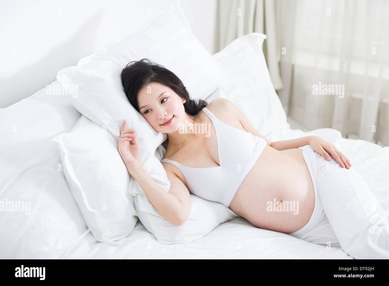 Pregnant women lying on bed hi-res stock photography and images - Page 5 -  Alamy