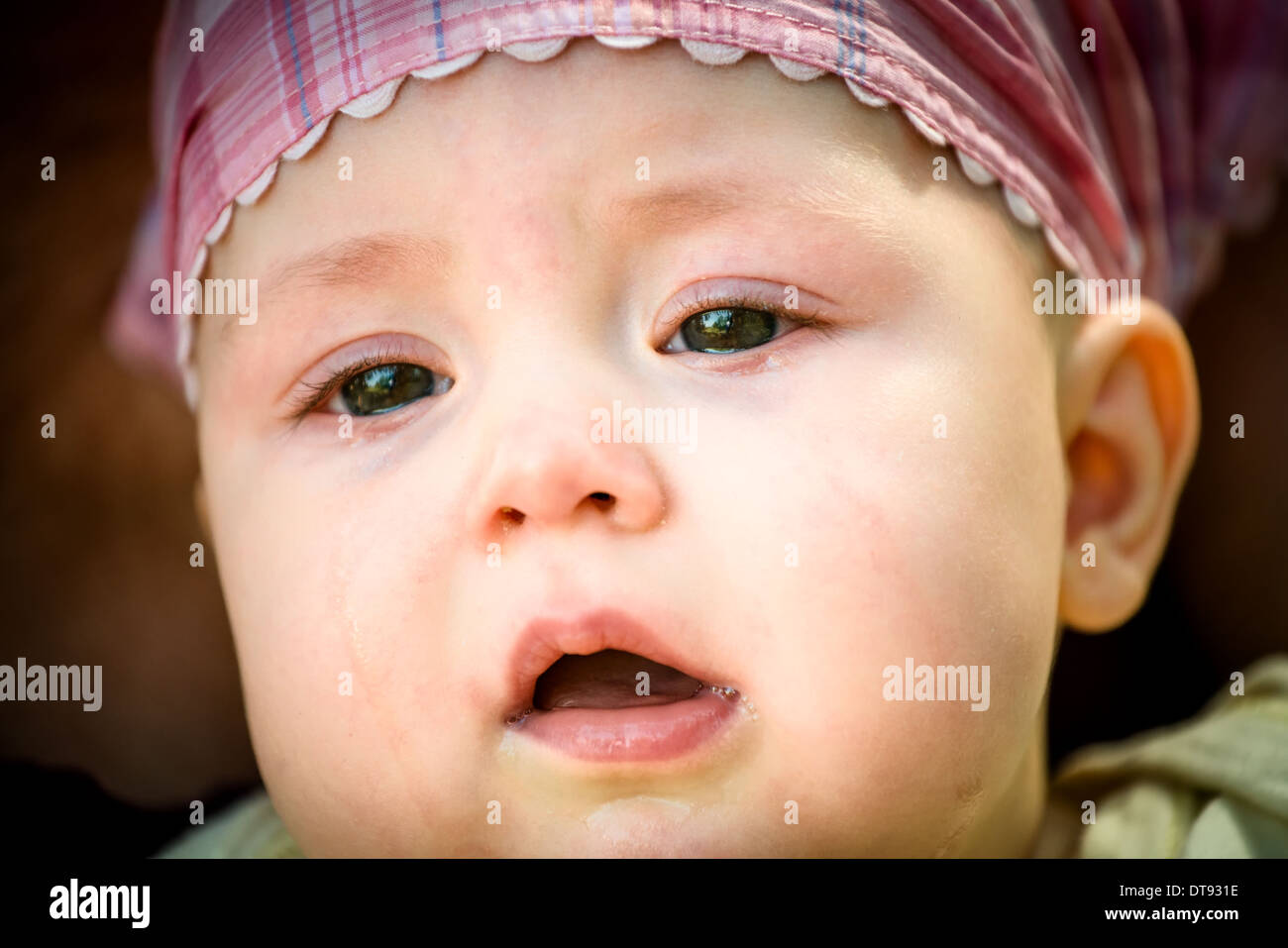 Unhappy baby portrait - detail of face, tears visible Stock Photo