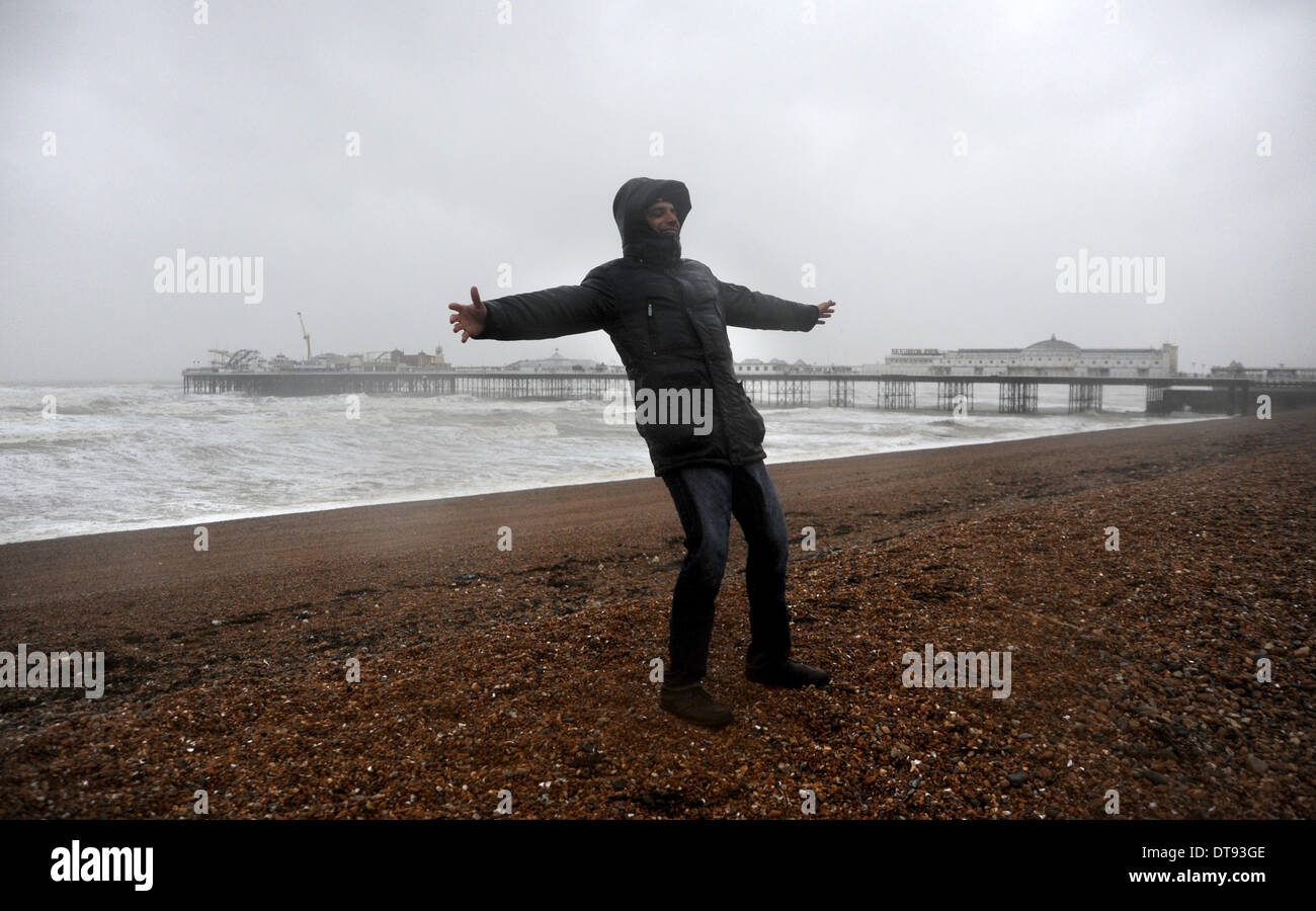 Visitors brave the wind and rain on Brighton seafront as another set of storms batter Britain Stock Photo