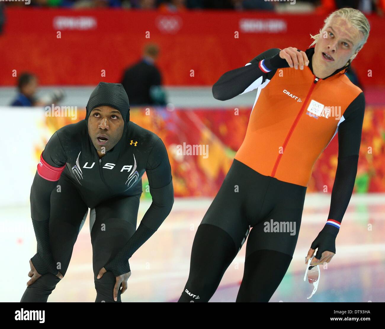 Sochi, Russia. 12th Feb, 2014. Shani Davis of USA and Koen Verweij (R) of  the Netherlands react during the Men's 1000m Speed Skating event in the  Adler Arena at the Sochi 2014
