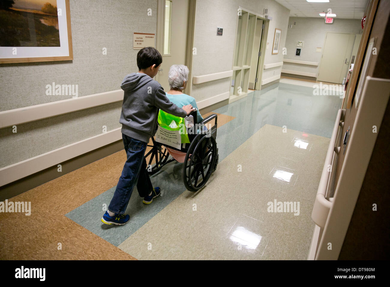 Grandson pushes his elderly senior citizen grandmother in a wheelchair ...