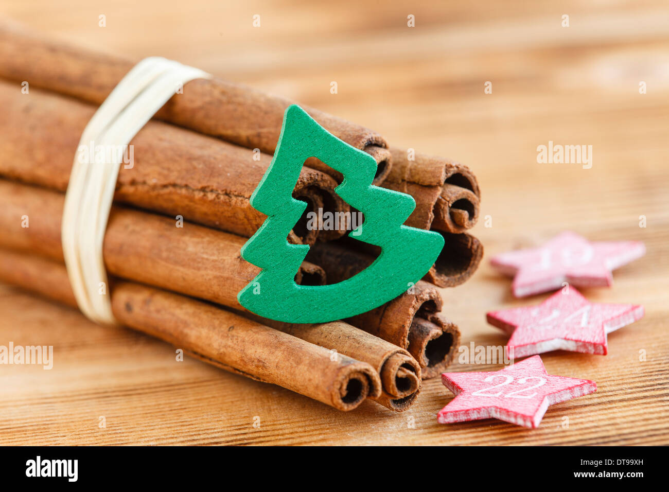 Cinnamon sticks with fir tree wood Stock Photo