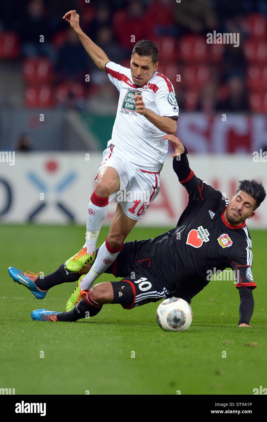 Leverkusen, Germany. 12th Feb, 2014. Leverkusen's Emre Can (R) vies for the ball with Kaiserslautern's Karim Matmour (L) during the DFB Cup quarter final match between Bayer Leverkusen and FC Kaiserslautern at BayArena in Leverkusen, Germany, 12 February 2014. Photo: FEDERICO GAMBARINI (ATTENTION: The DFB prohibits the utilisation and publication of sequential pictures on the internet and other online media during the match (including half-time). Credit:  dpa picture alliance/Alamy Live News Stock Photo