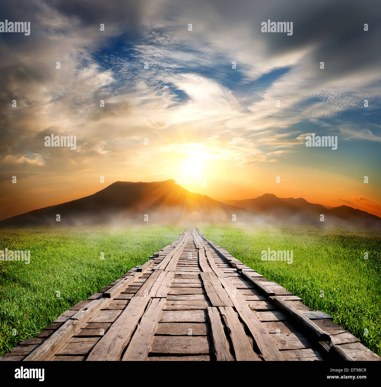 Wooden road in the mountains at sunset Stock Photo