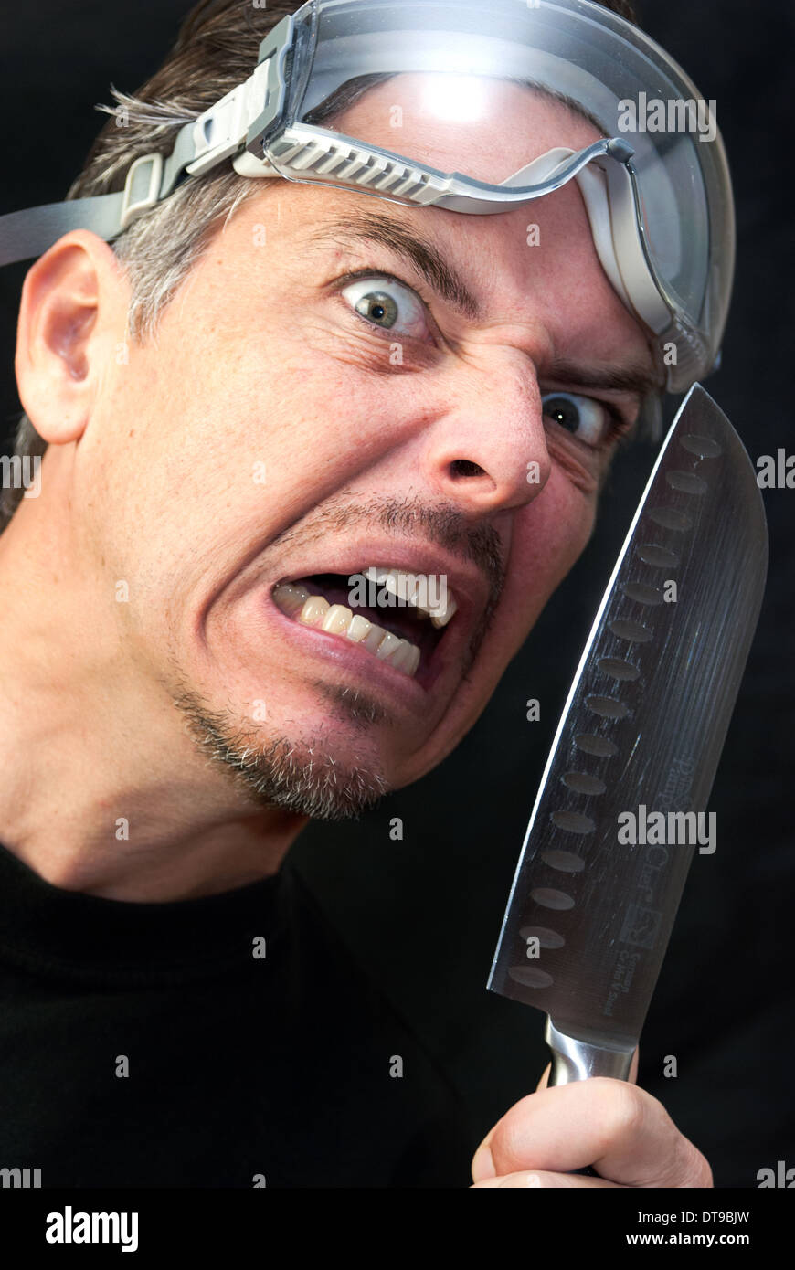 Close-up of a crazy man with a knife. Stock Photo