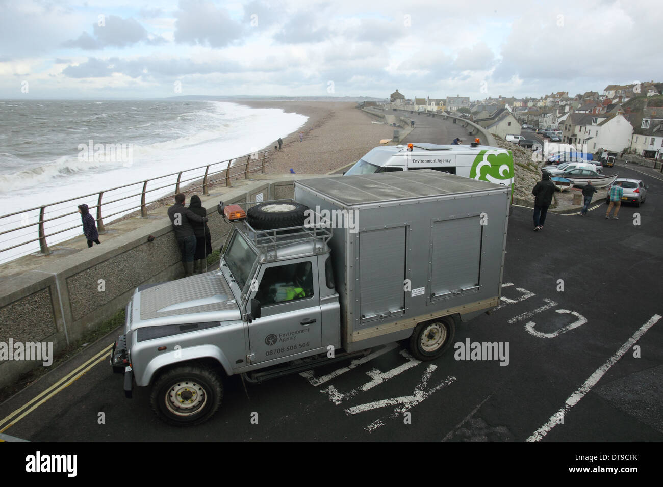 Environment agency monitoring Chesil beach sea defences during stormy weater , Chesil beach Dorset UK November Stock Photo