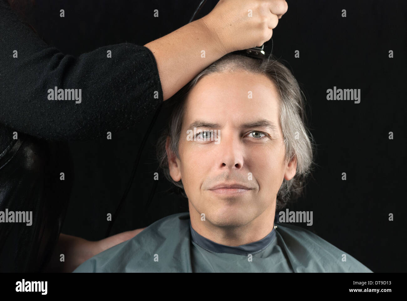 Man Getting Long Hair Shaved Off For Cancer Fundraiser Stock Photo