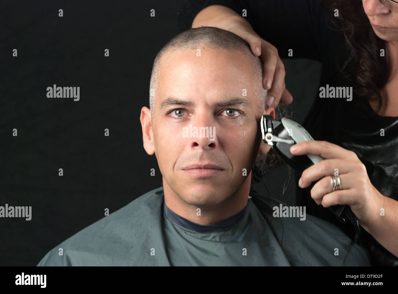 Mourning Man Gets Head Shaved For Fundraiser, Looks To Camera Stock Photo