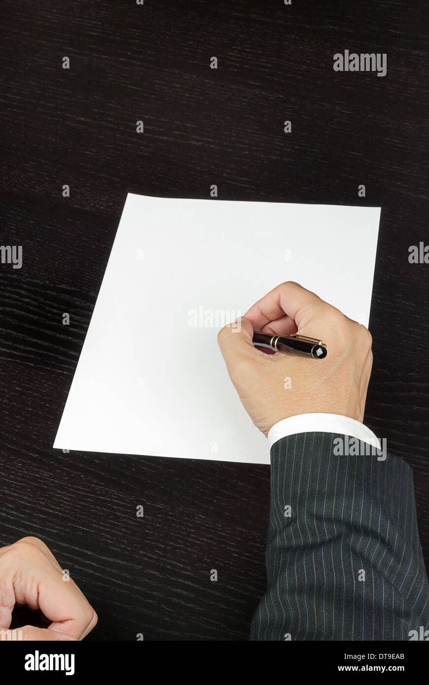 Close-up of a businessman writing, shot from above. Stock Photo