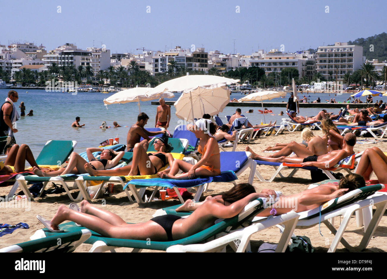 People sunbathing on the beach in San Antonio, Ibiza, Spain Stock Photo