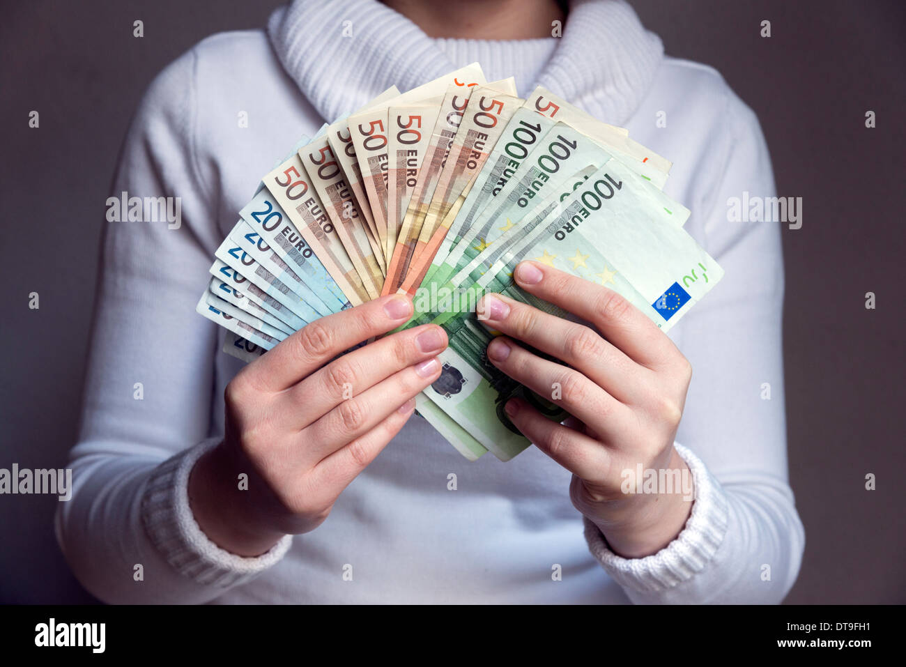 Woman holding wad of Euro banknotes Stock Photo