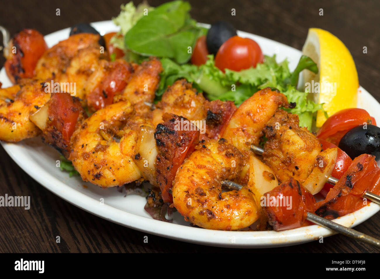 Grilled king prawns on a skewer Stock Photo