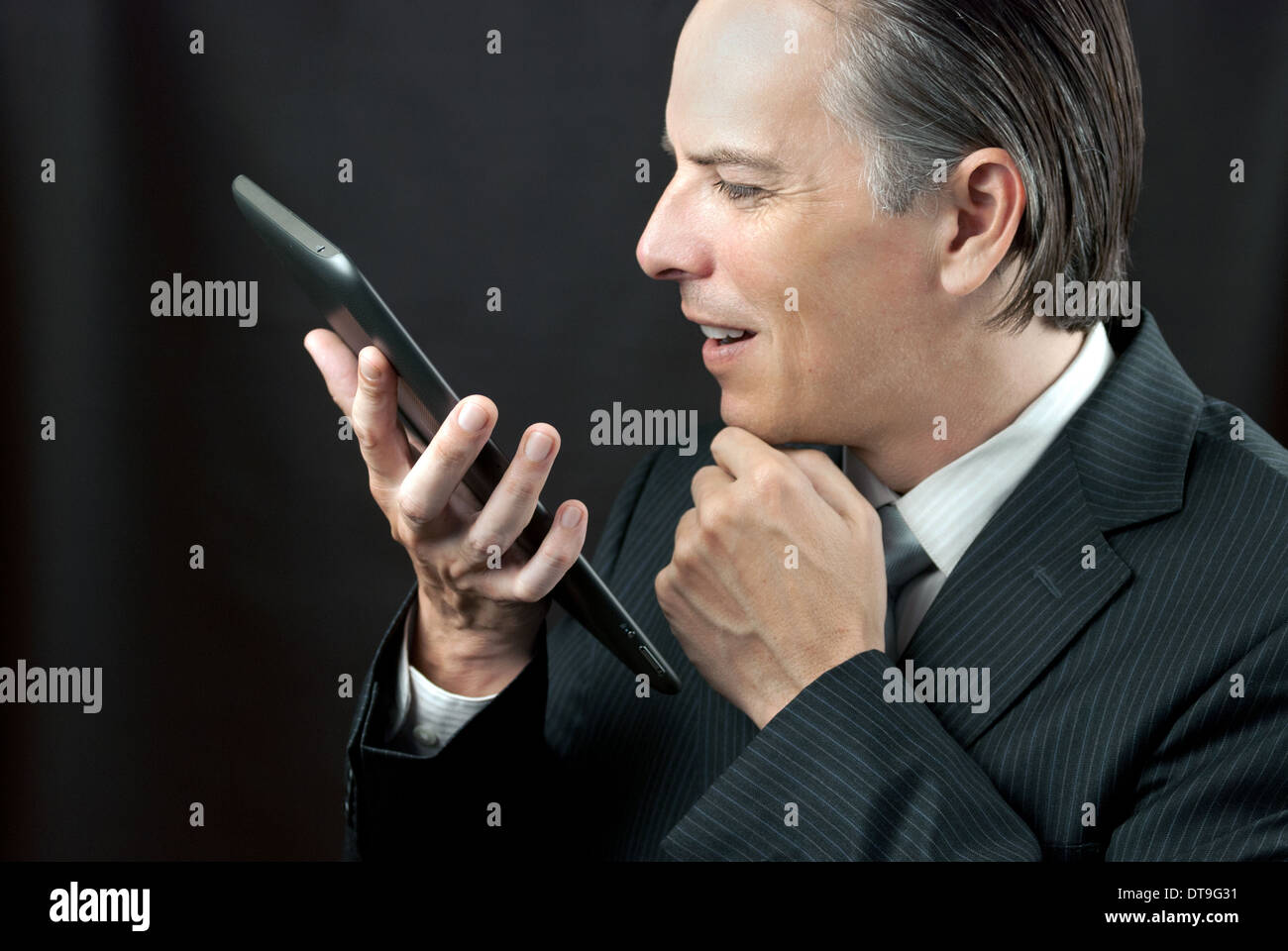 Close-up of a businessman admiring his tablet. Stock Photo