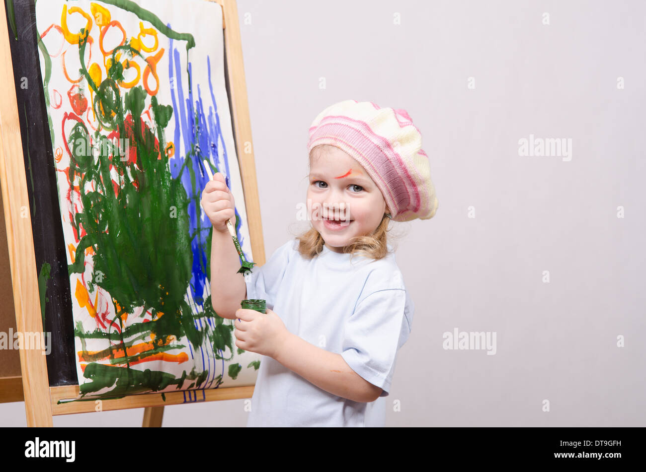 three-year-old-girl-playing-in-the-artist-girl-draws-on-the-easel