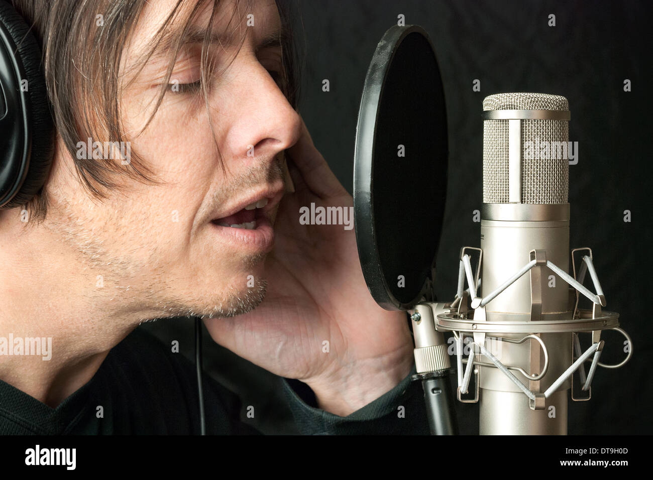 Serious Man Records Vocals In Stuio Stock Photo