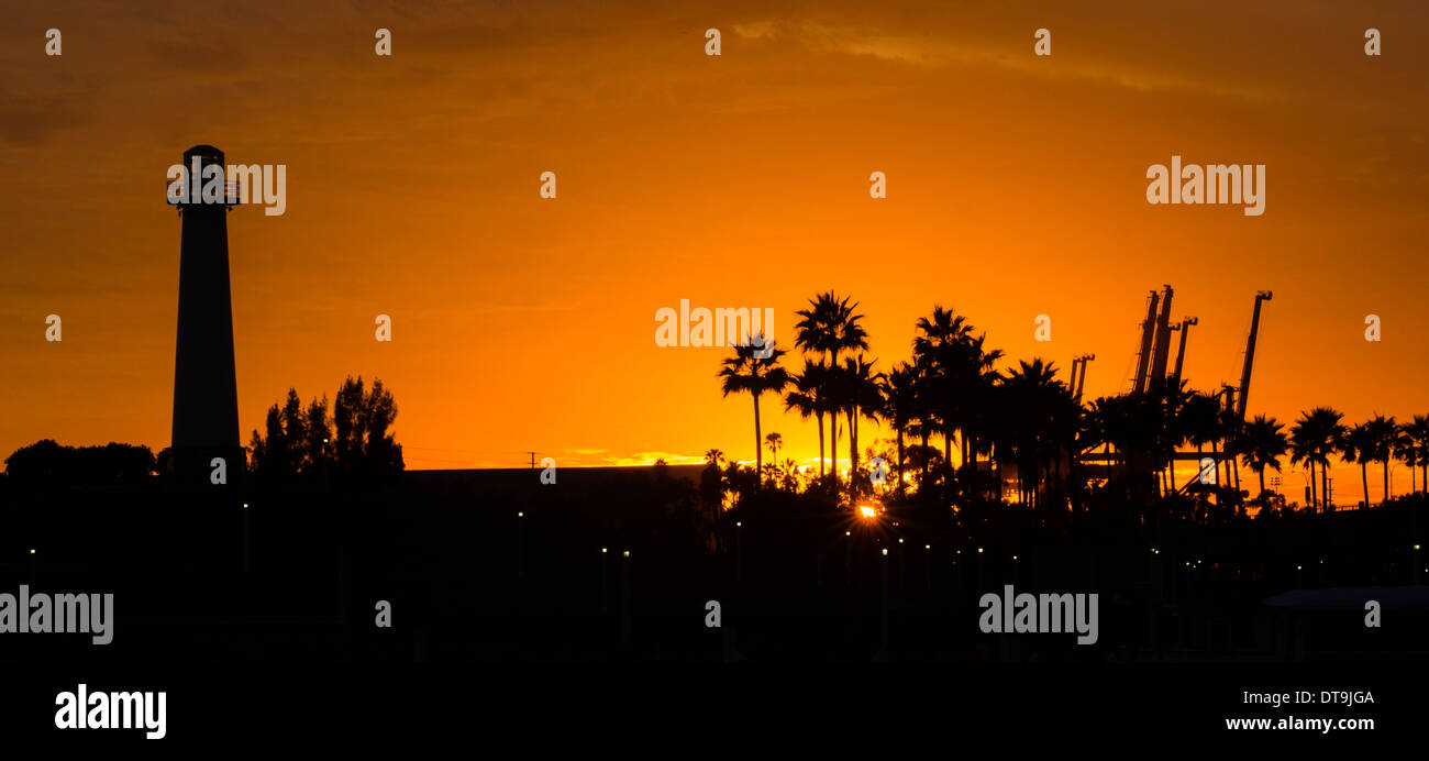 The lighthouse, palm trees and refinery. Stock Photo