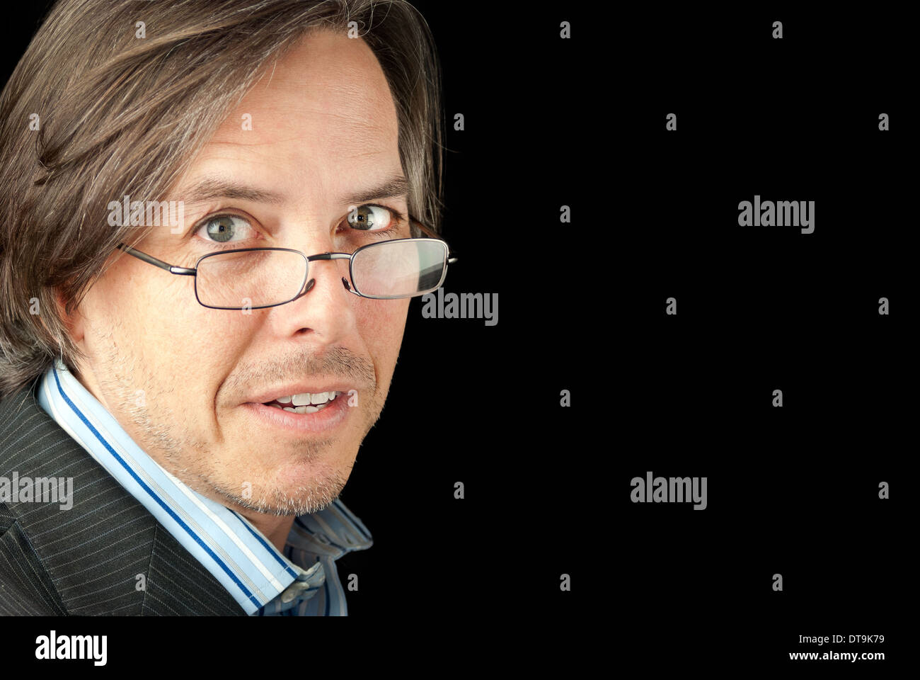 Close-up of a anxious businessman wearing glasses looking to camera. Stock Photo