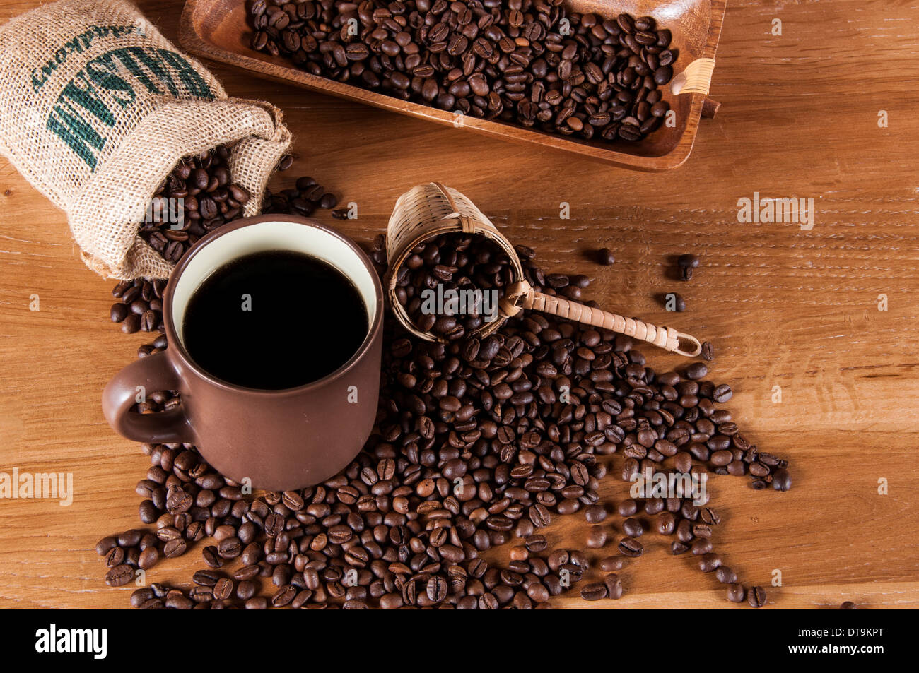 Coffee theme with wooden table and dark background Stock Photo - Alamy