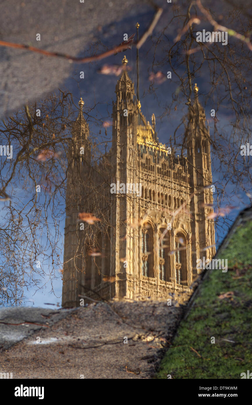 The Tower of the Houses of Parliament at Westminster reflected in a puddle,London,UK Stock Photo