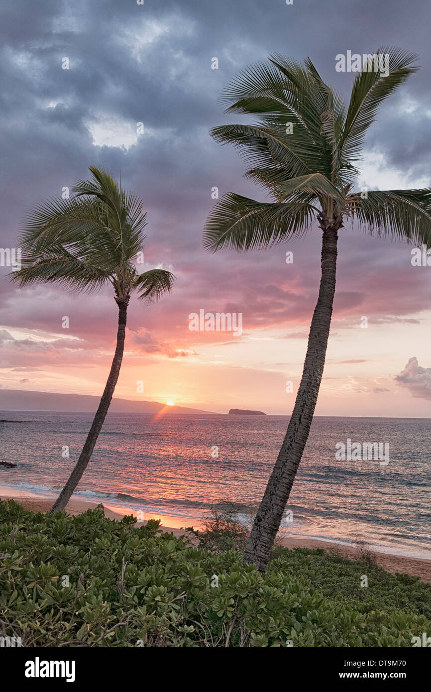 Makena Beach view of setting sun over the offshore islands of Kahoolawe and Molokini on Hawaii's island of Maui. Stock Photo