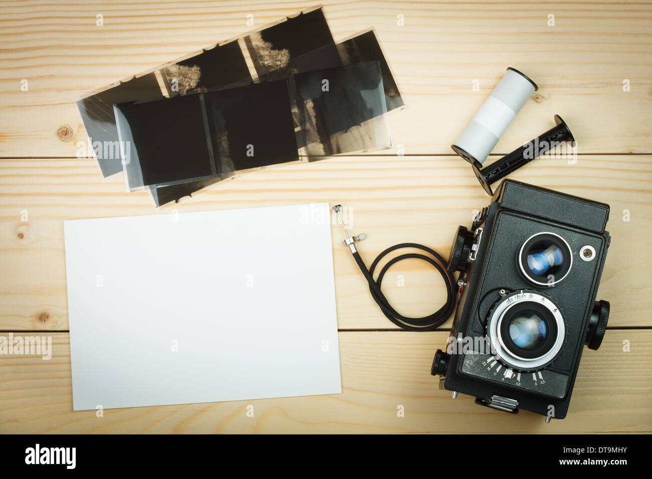 Old retro camera and film roll on wooden boards. Empty space on your text Stock Photo