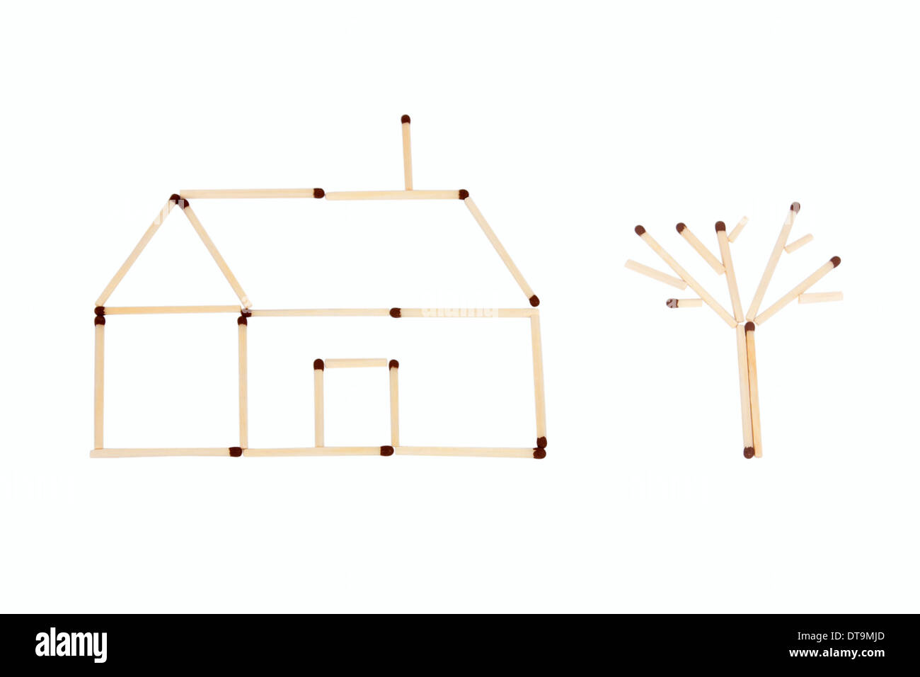 Small house and one tree made of stick matches Stock Photo