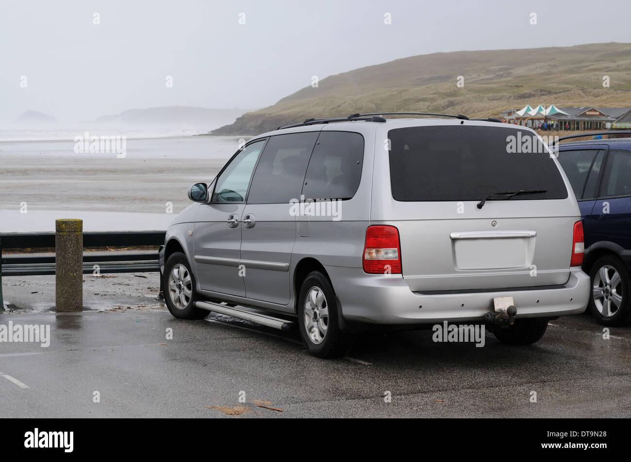 Silver people carrier parked on the beach in Cornwall Stock Photo