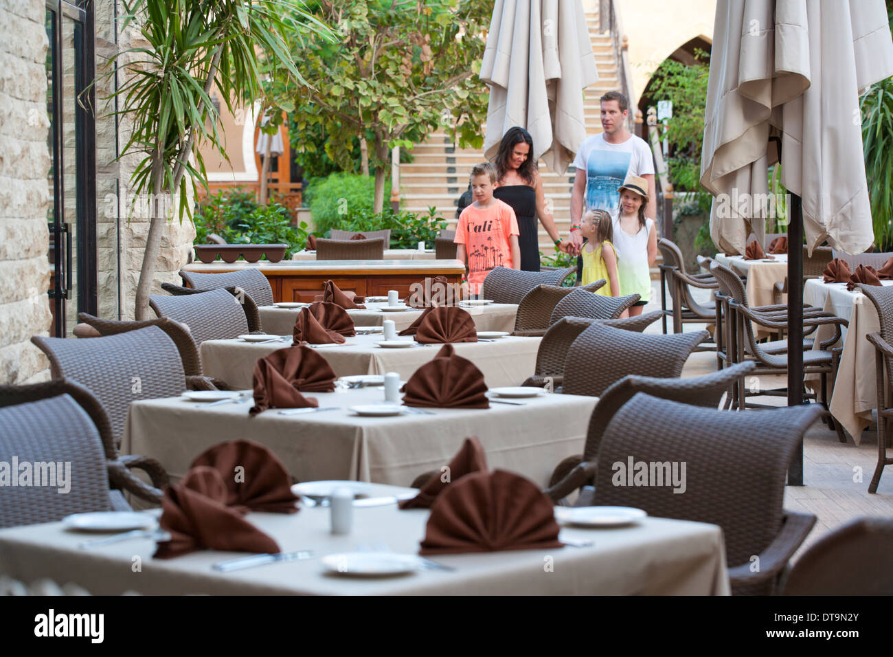 Selective focus image of a family approaching a hotel restaurant in Egypt Stock Photo
