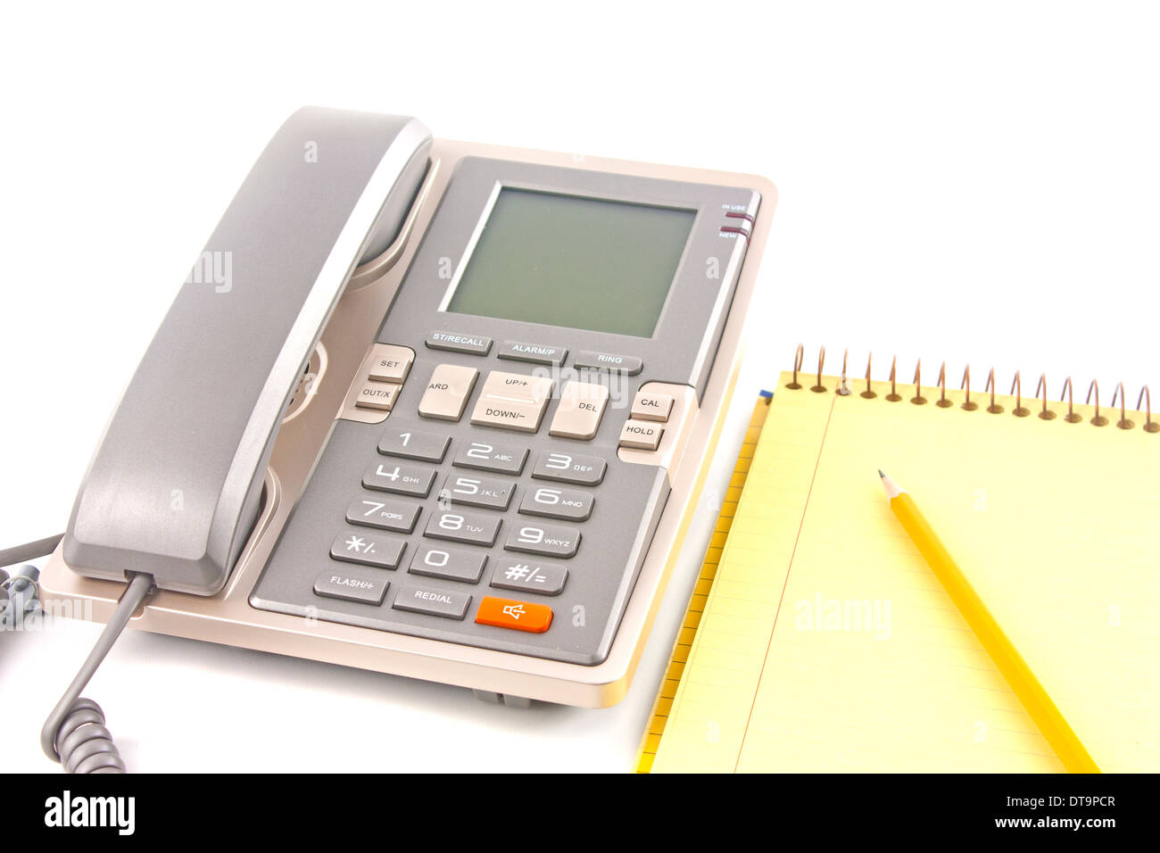 Phone and one spiral notebook with one pencil isolated over white background Stock Photo