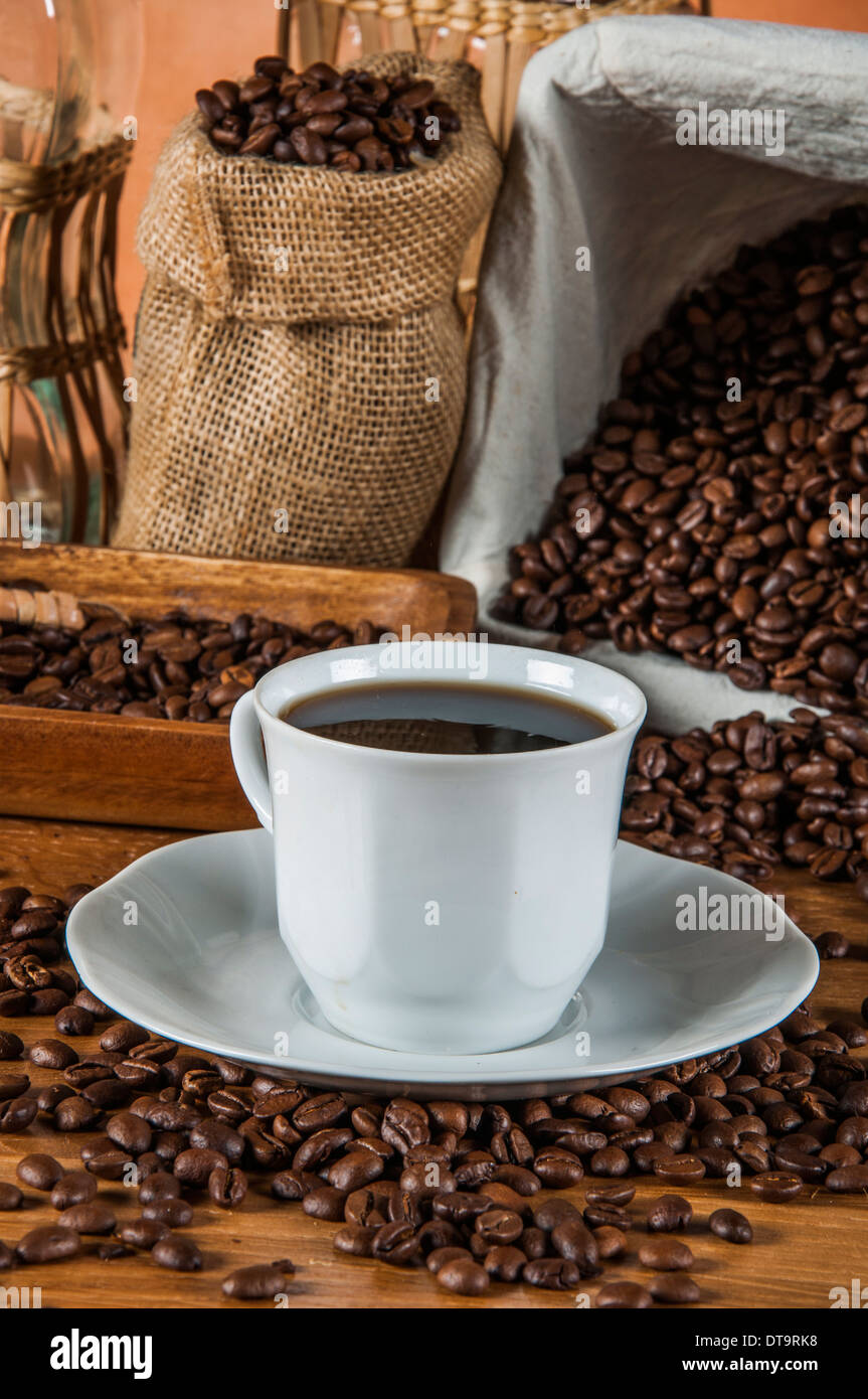 Coffee theme with wooden table and dark background Stock Photo - Alamy