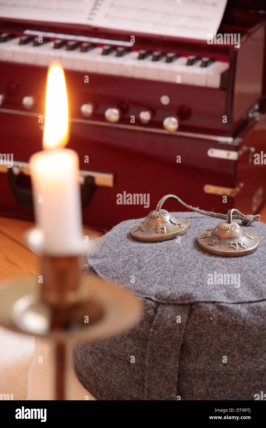 Candle, harmonium and cymbal as decoration in a yoga room Stock Photo