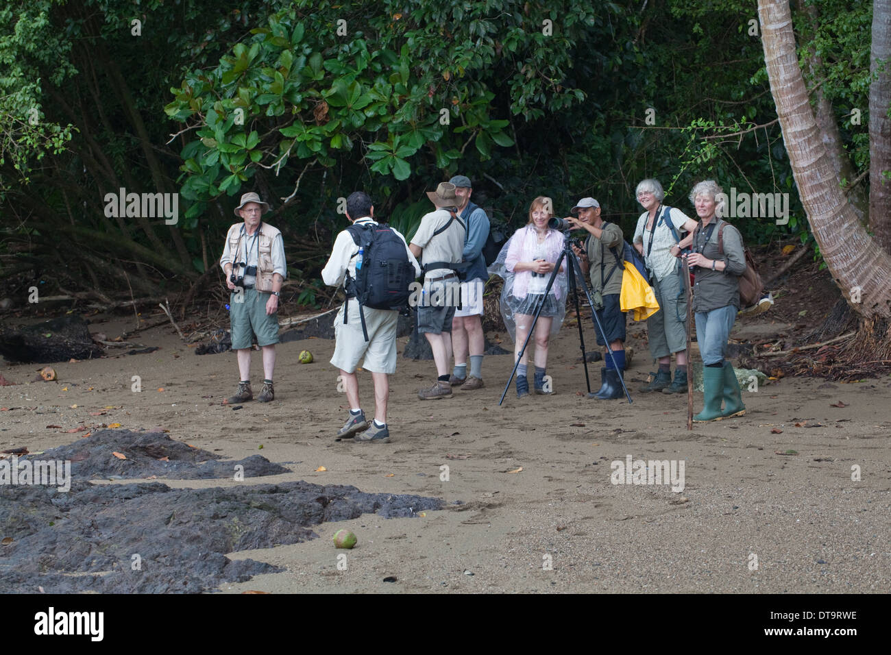 Eco-tourists and local guide demonstrating optical aid equipment. Costa Rica. Central America. Stock Photo