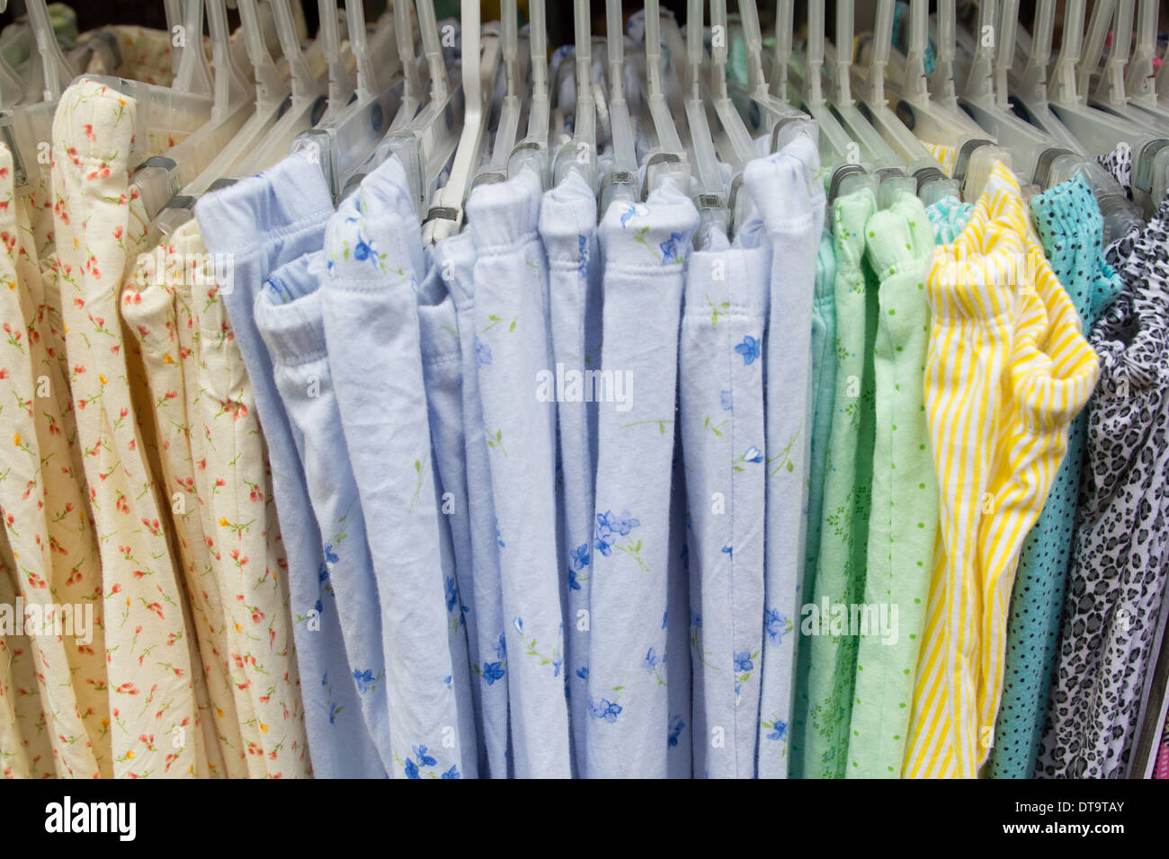 Clothes in hangers for background Stock Photo - Alamy