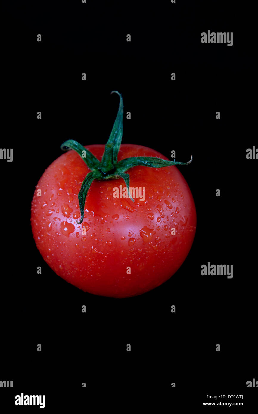 Red Tomatoes on black background Stock Photo - Alamy