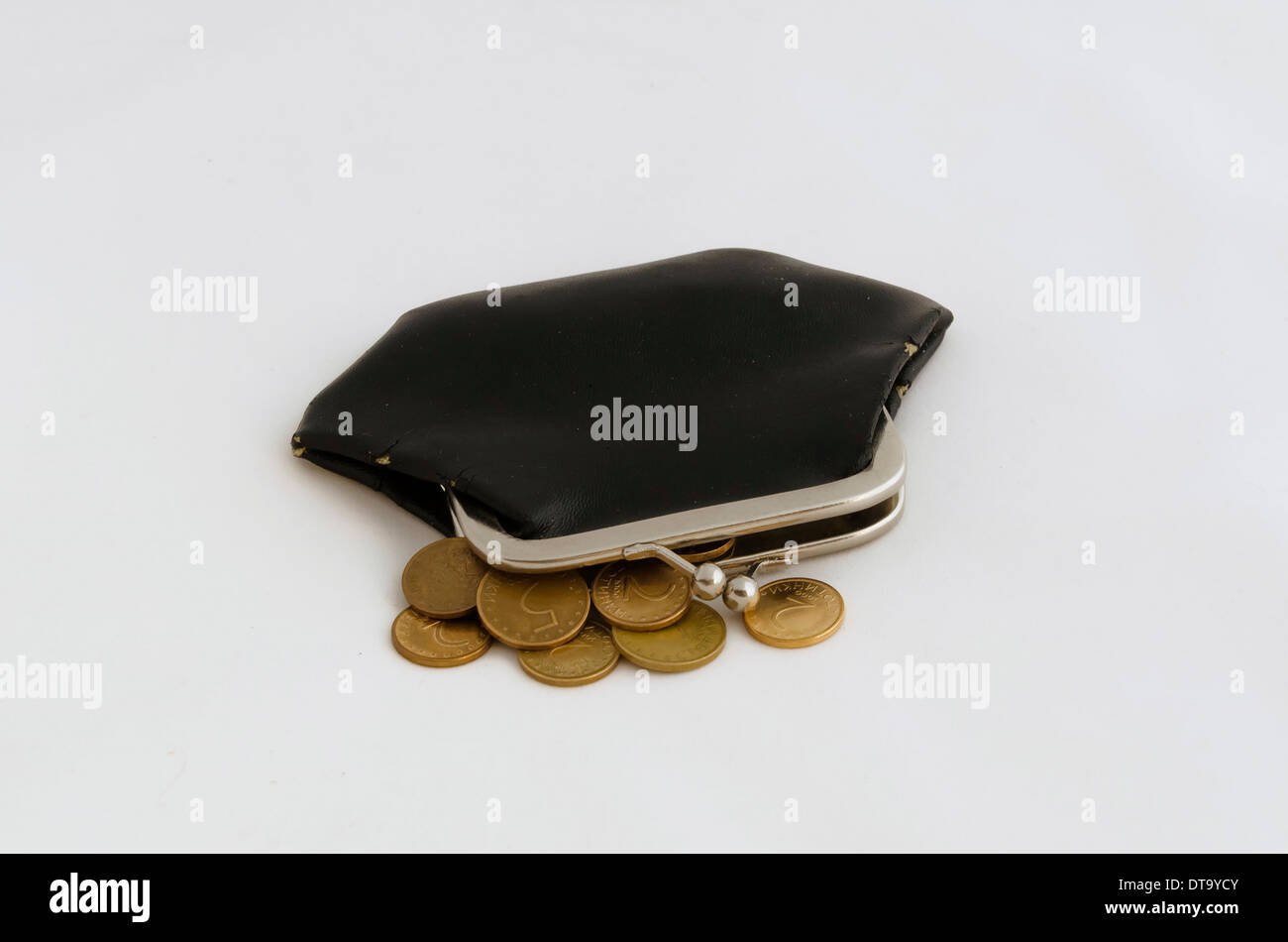 Old tear purse with yellow coin at white background Stock Photo