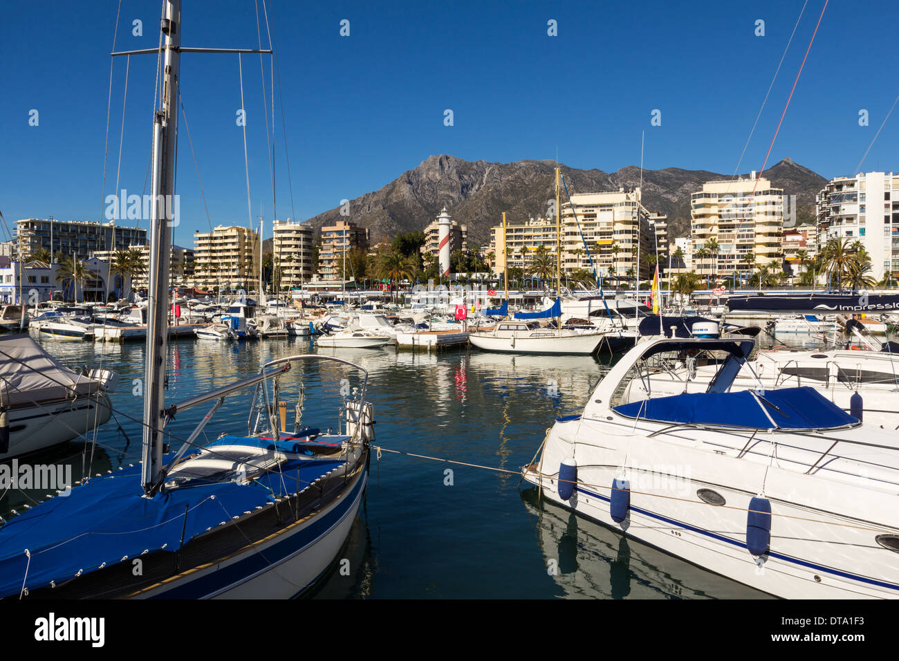 MARBELLA SPAIN SEA FRONT WITH LIGHTHOUSE AND BOATS IN THE HARBOUR Stock Photo