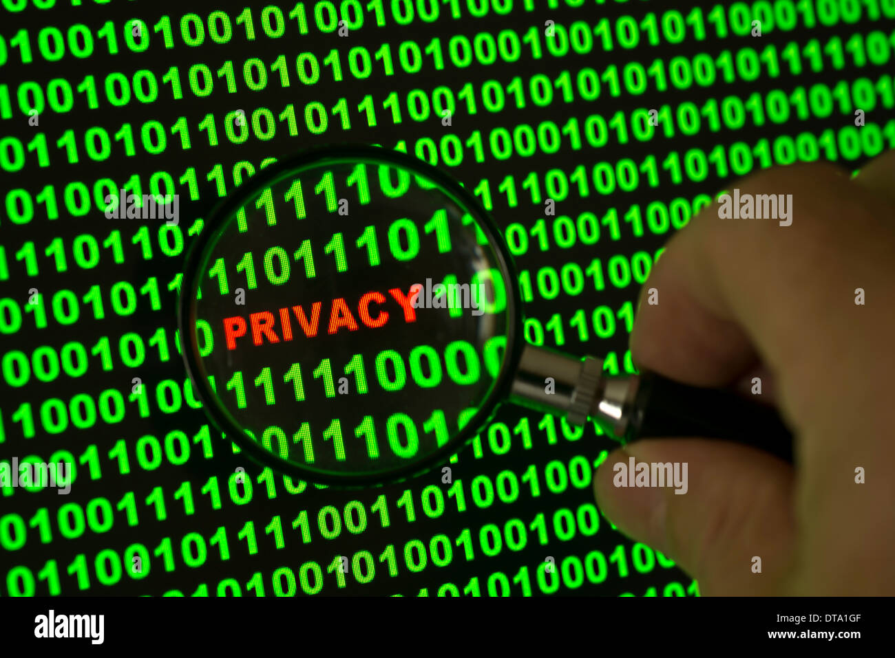 Binary code with the word 'Privacy' viewed through a magnifying glass Stock Photo