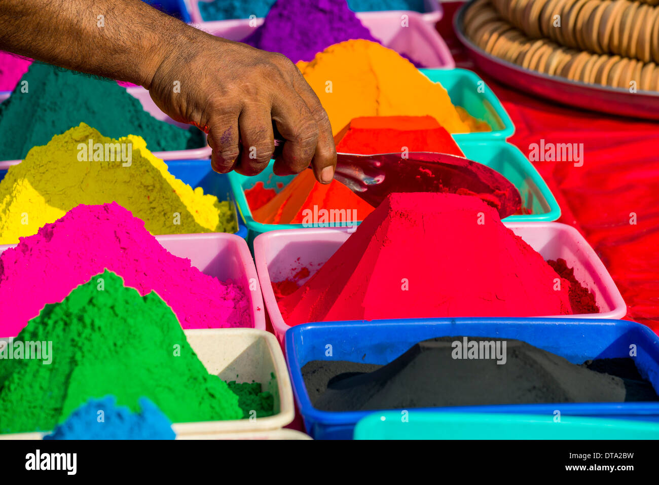 Colour powder in different colors is displayed in heaps for sale, Mumbai, Maharashtra, India Stock Photo