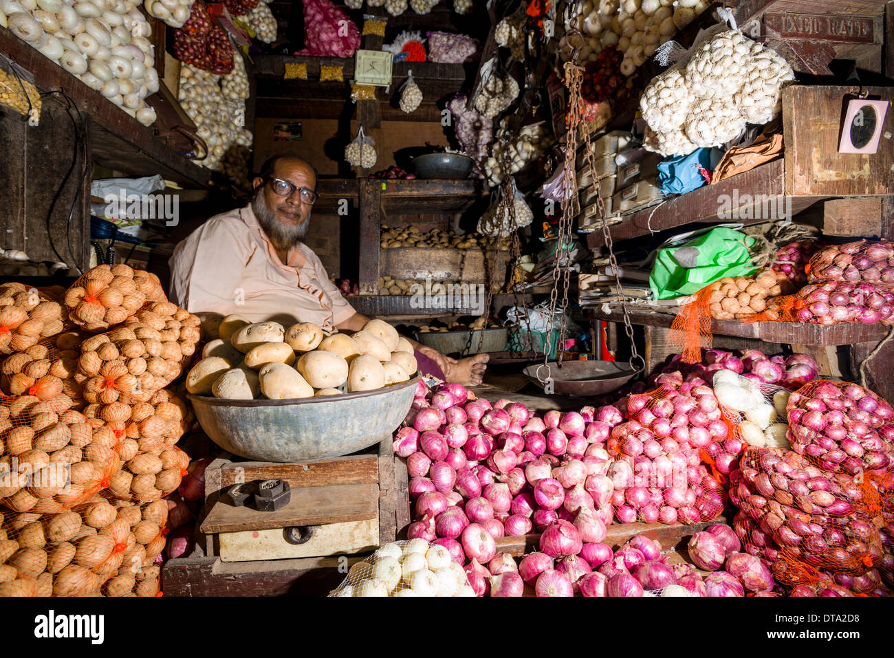 Man selling potatoes and onions at Crawfort Market, Mumbai, Maharashtra, India Stock Photo