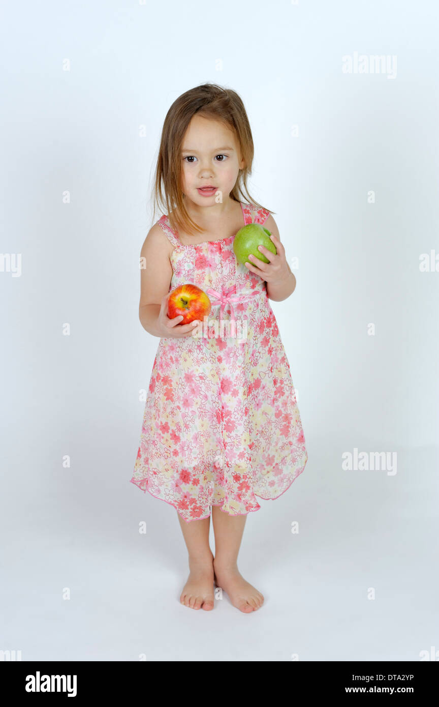 Girl with a red and a green apple Stock Photo