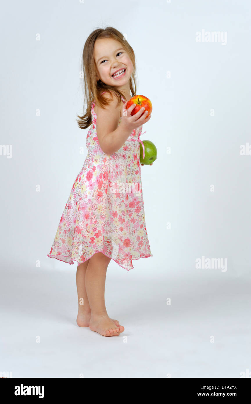 Girl with a red and a green apple Stock Photo