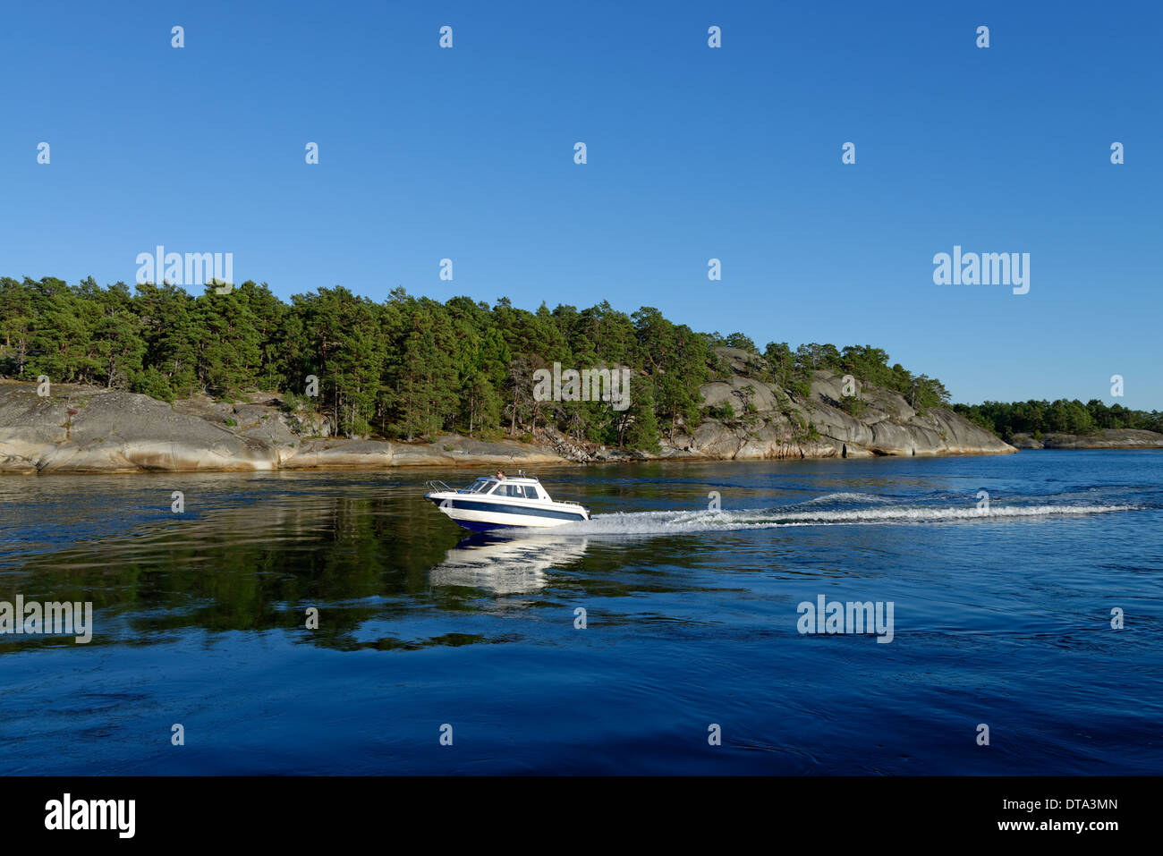 Motorboat off the island of Soder Langjolm, viewed from Finnhamn Island, Stockholm Middle Archipelago, Stockholm, Sweden Stock Photo
